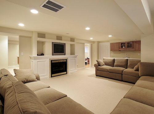 Basement in luxury home with white fireplace